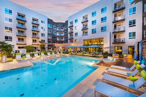 Orange apartment for rent - Swimming pool at dusk at Avel Apartment Homes in Orange CA