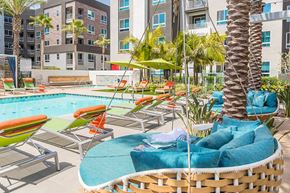 Orange apartment for rent - Pool Vibe Swings and Lounge Chairs Angled at Vita Apartment Homes in Orange CA