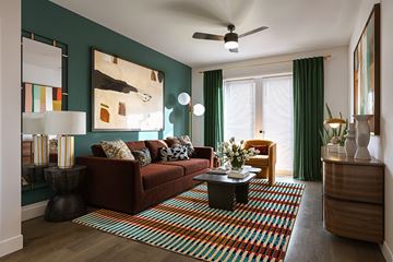 Farmers Branch apartment for rent - A living room with a red couch and a striped rug.