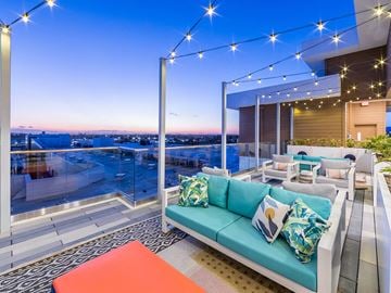 Fremont apartment for rent - a living room with a blue couch and a balcony