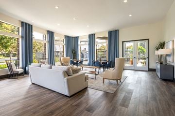 Chula Vista apartment for rent - A spacious living room with a white couch and a wooden floor.