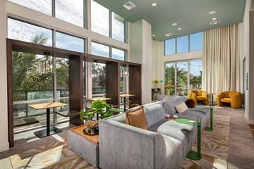 San Diego apartment for rent - A modern living room with a large grey couch and a coffee table.