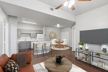 Houston apartment for rent - A modern living room with a brown sofa and a wooden coffee table.
