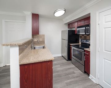 San Diego apartment for rent - a kitchen with granite counter top and stainless steel appliances