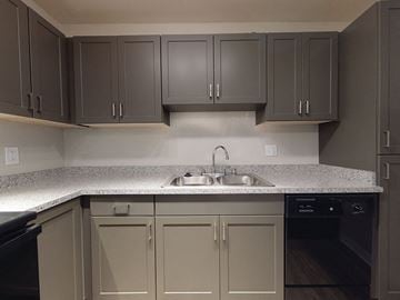 National City apartment for rent - a kitchen with white counter tops and gray cabinets