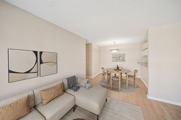 Longmont apartment for rent - A living room with a couch, a table, and a painting on the wall.