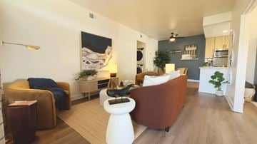 Encinitas apartment for rent - A living room with a brown couch and a white stool.