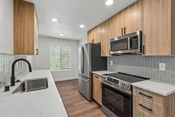 Encinitas apartment for rent - A modern kitchen with wooden cabinets and stainless steel appliances.