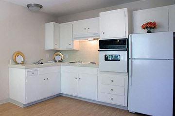 San Jose apartment for rent - a white kitchen with white cabinets and a refrigerator