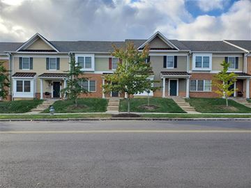 District Heights townhouse for rent - A row of houses with green trees in front.