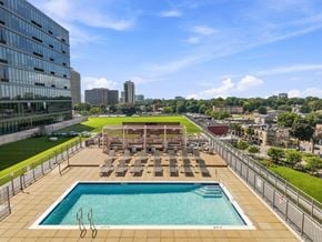 Fort Lee apartment for rent - A rooftop pool with sun loungers and a view of the city.