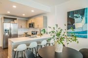 Fort Lee apartment for rent - A modern kitchen with a dining table and chairs.