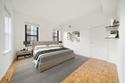 Hoboken apartment for rent - A bedroom with a large bed and a window.