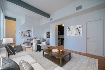 Hoboken apartment for rent - A living room with a white couch and a coffee table.