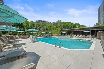 Pool deck with lounge chairs and covered cabanas