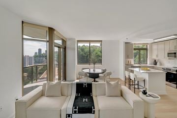 Edgewater apartment for rent - A modern living room with a white couch and a black and white rug.