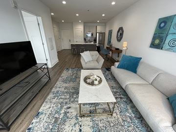 Branford apartment for rent - A modern living room with a white sofa and a coffee table.