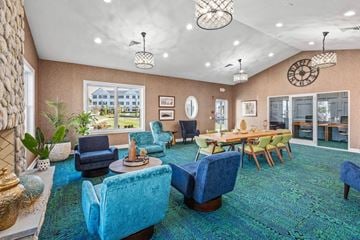Milford apartment for rent - A living room with blue chairs and a green rug.