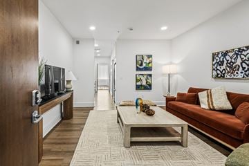 Milford apartment for rent - A living room with a brown couch and a wooden coffee table.