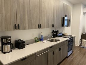 New Haven apartment for rent - A kitchen with wooden cabinets and a white countertop.
