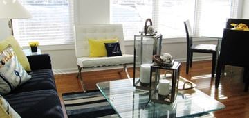 Milford apartment for rent - A living room with a white chair and a glass table.