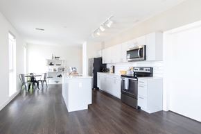 Detroit apartment for rent - A modern kitchen with white cabinets and appliances.