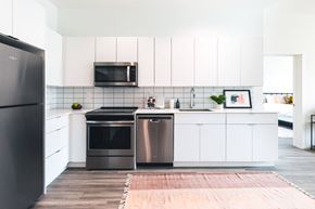 Detroit apartment for rent - A modern kitchen with a black refrigerator and stainless steel appliances.