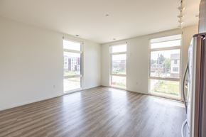 Detroit apartment for rent - A large empty room with wooden floors and white walls.