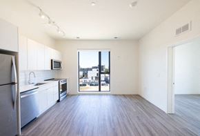 Detroit apartment for rent - a kitchen with a stove top oven next to a refrigerator