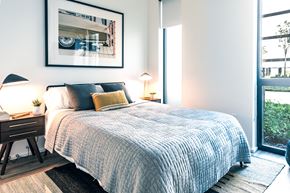 Detroit apartment for rent - a bedroom with a large bed and a large window