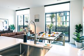 Detroit apartment for rent - a kitchen with a table and chairs and a sink with a view of a living room
