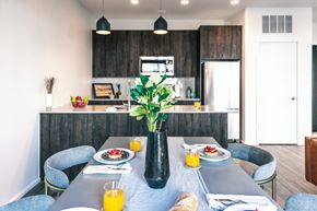 Detroit apartment for rent - a dining area with a table and chairs and a kitchen in the background
