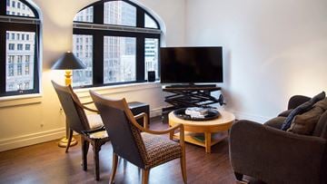 Detroit apartment for rent - a living room with a table and chairs and a television