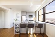 Detroit apartment for rent - One bedroom unit with open kitchen, a large window and a counter with three chairs at Book Tower, Michigan, 48226