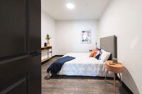 Cleveland apartment for rent - Spacious bedroom with wall art and modern styling at The May.