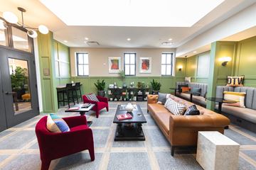 Detroit apartment for rent - a living room with couches and chairs and a table