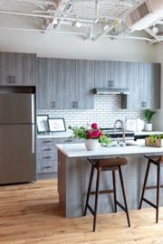 Detroit apartment for rent - Kitchen with Island and Grey Cabinets at The Assembly, Detroit, MI