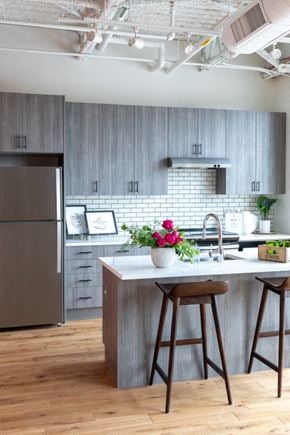 Detroit apartment for rent - Kitchen with Island and Grey Cabinets at The Assembly, Detroit, MI