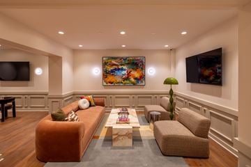 Detroit apartment for rent - A living room with a brown couch, a coffee table, and a painting on the wall.