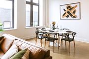 Detroit apartment for rent - a dining room with a table and chairs and a couch in a 555 waverly unit at The Ferguson Apartments, Detroit, Michigan
