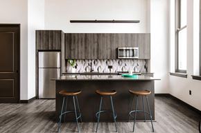 Cleveland apartment for rent - Gourmet kitchen with island, modern appliances, and elegant backsplash at The May.
