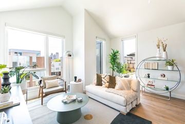 Detroit apartment for rent - A living room with a white couch and a glass coffee table.