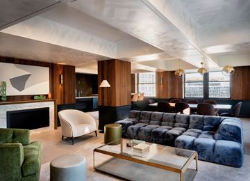 Detroit apartment for rent - a shared amenity living room with a blue couch and a coffee table