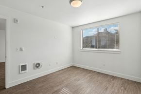 Portland apartment for rent - A room with a window and a wall-mounted air conditioner unit.
