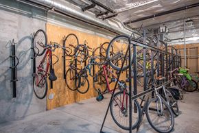 Portland apartment for rent - a collection of bikes hanging on a wall in a garage