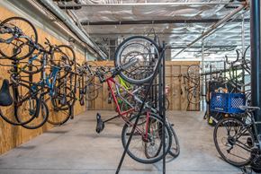 Portland apartment for rent - a group of bikes hanging on a rack in a bike shop