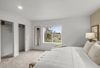 Bedroom with natural light and dual closets