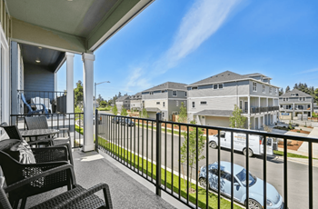 Covered balcony overlooking residential neighborhood