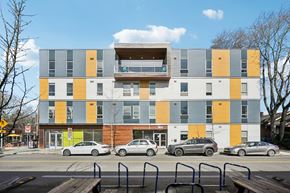 Portland apartment for rent - A modern multi-story building with a balcony on the top floor.
