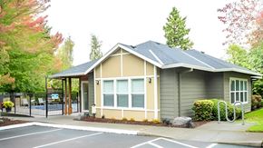 Tigard apartment for rent - A small building with a grey roof and a white door.